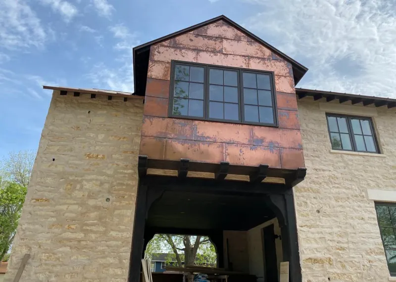 Copper metal panel facade on a stone building for Skylight Installation in Park City
